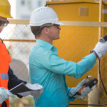 Engineers inspecting pipelines and recording data with tools to ensure compliance with EPA LDAR regulations standards