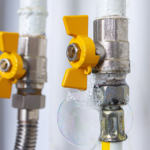 Gas valve with visible soap bubbles indicating a leak, demonstrating a key step in how to detect a gas leak for safety.