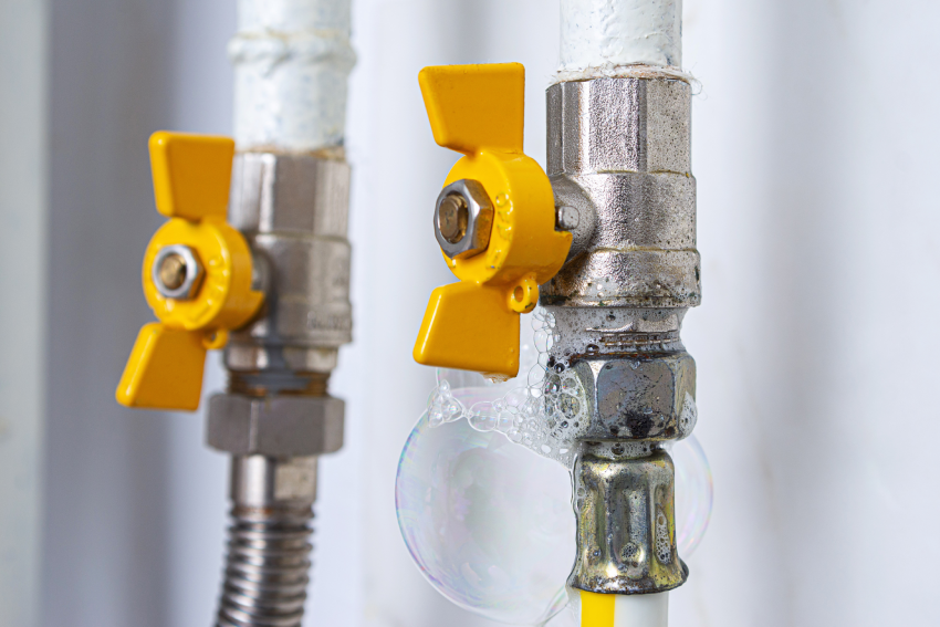 Gas valve with visible soap bubbles indicating a leak, demonstrating a key step in how to detect a gas leak for safety.
